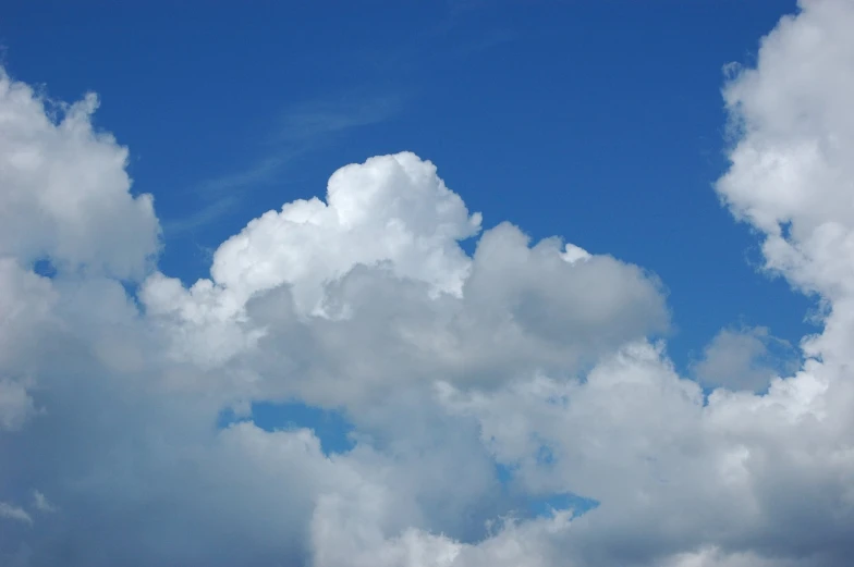 a cloudy blue sky with very large white clouds