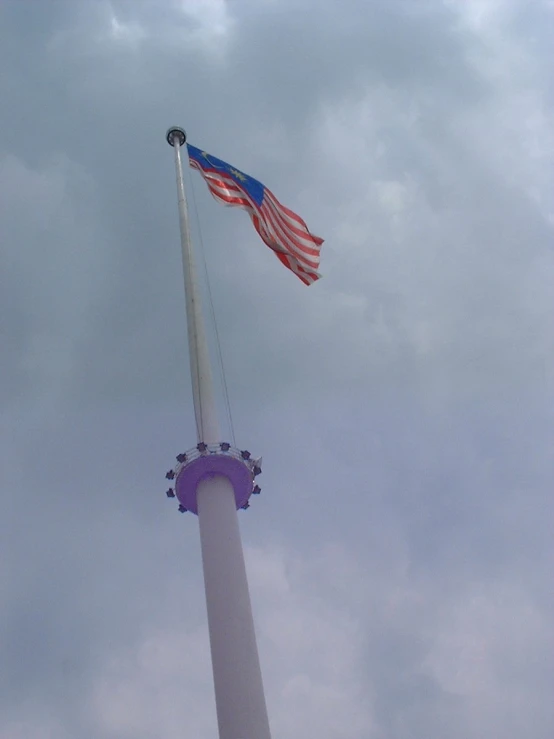 an american flag is flying on top of a flagpole