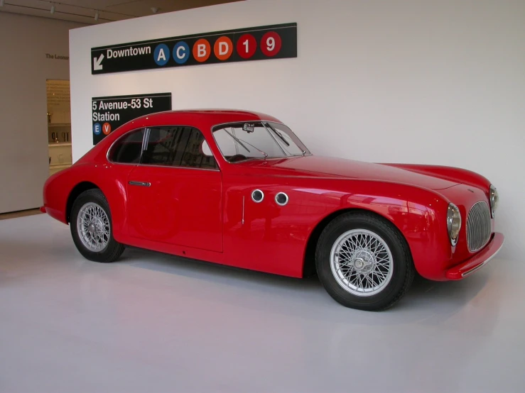 this red sports car has wheels on the rims