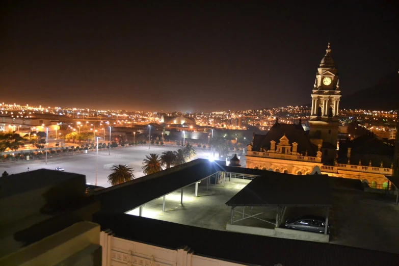 a cityscape with a clock tower and lights lit up