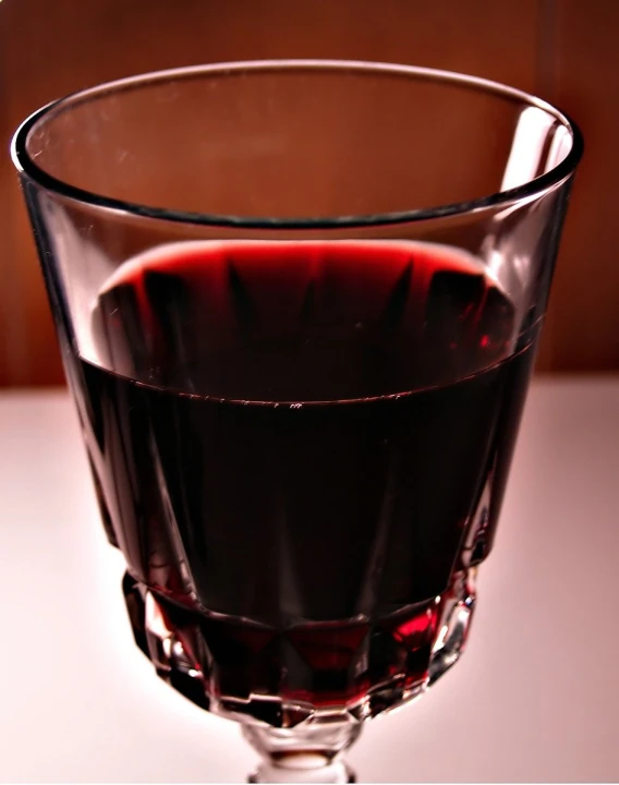 a close up of a glass with some wine