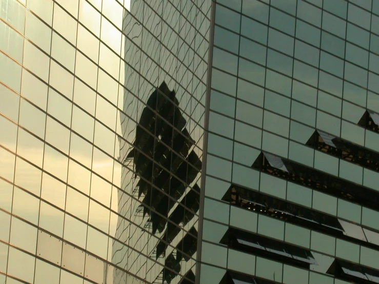 an image of a building that is reflecting the other buildings