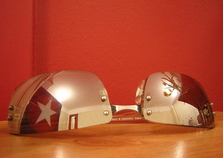 a pair of mirrored helmets with the logo of switzerland