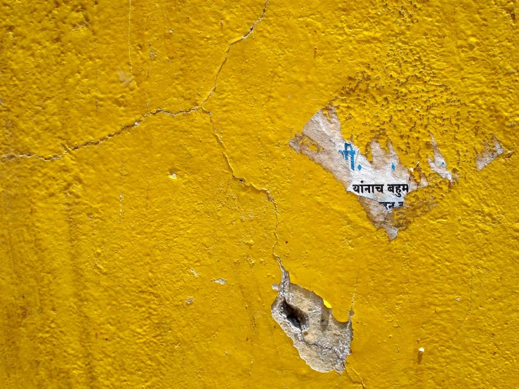 a piece of old paper taped to the side of an abandoned building