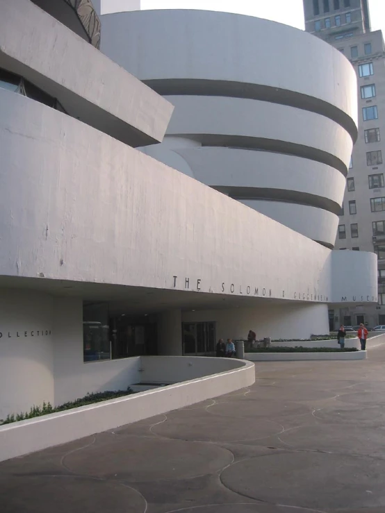 some people standing outside of an empty building