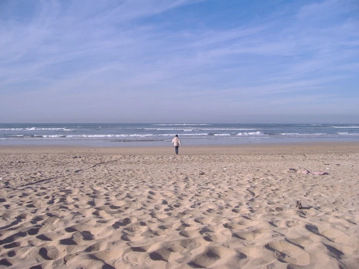 a man standing in the sand on a beach