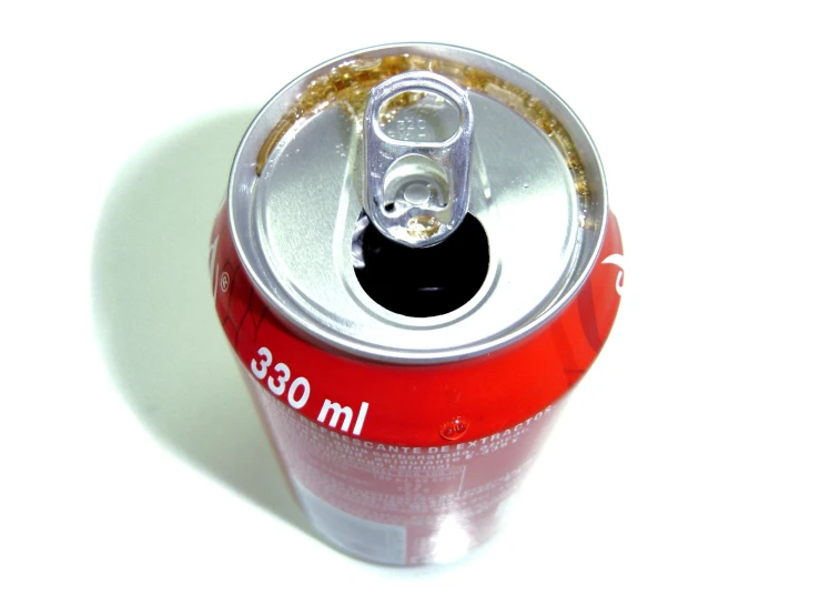 a can of soda on a white table