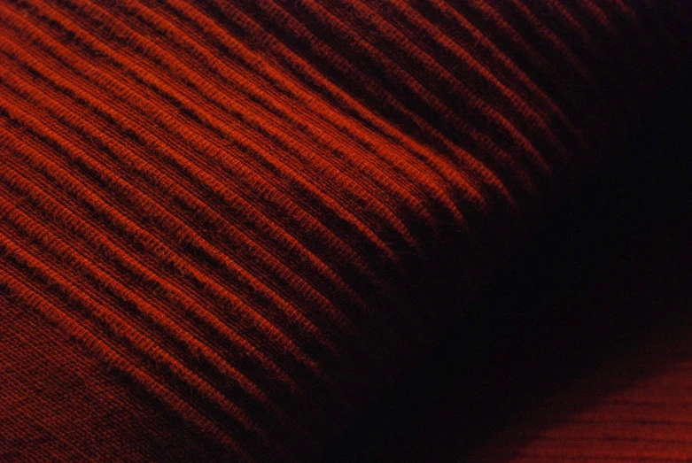 the background of a red striped material with very slight lines