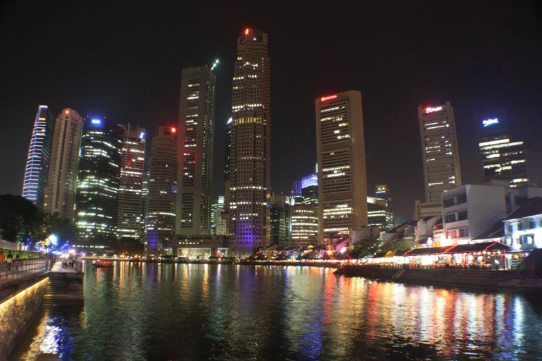 the skyline of a city is lit up at night