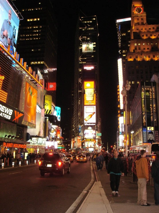 a number of people on a busy street at night