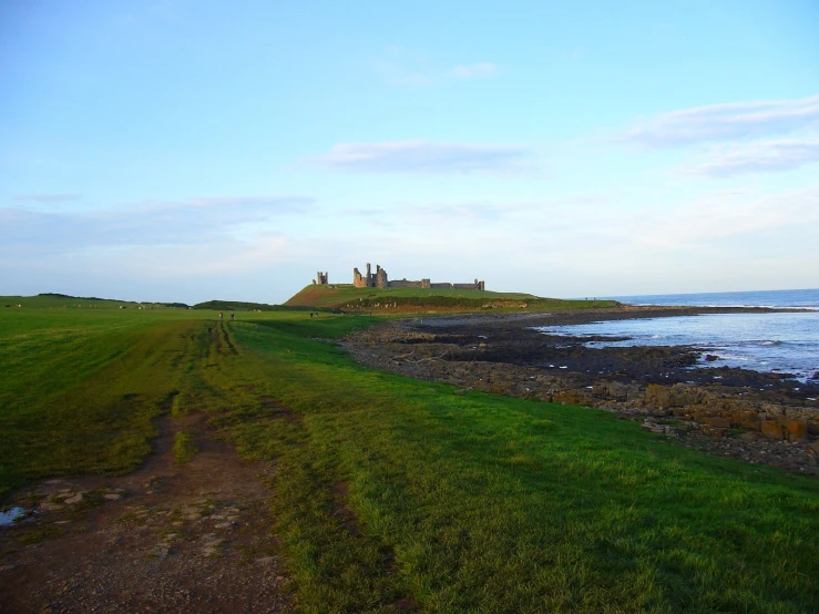 a castle sitting on top of a cliff near the ocean