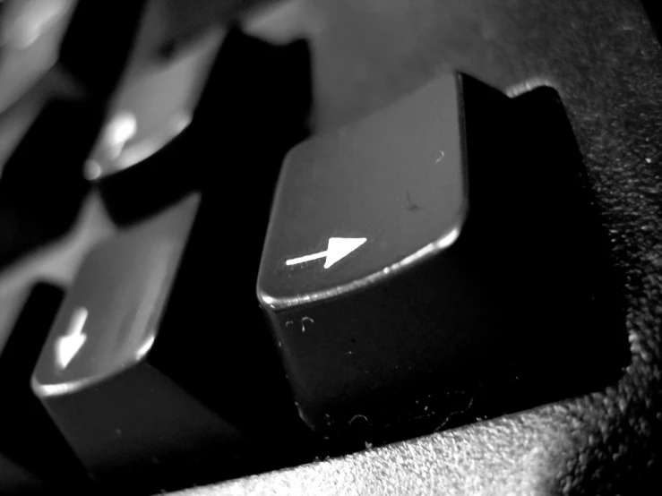 close up of a computer keyboard with an arrow key
