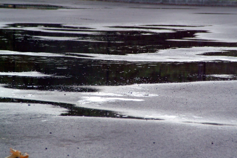 several pieces of ice are on the pavement