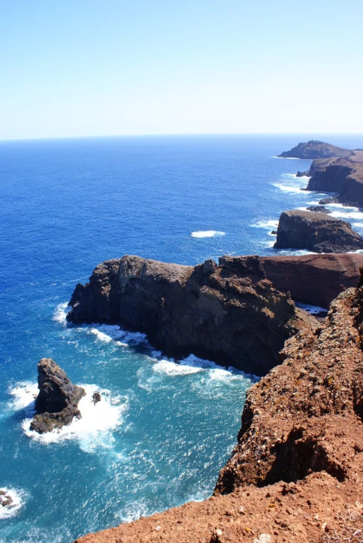 a couple of rocky coastline with some water