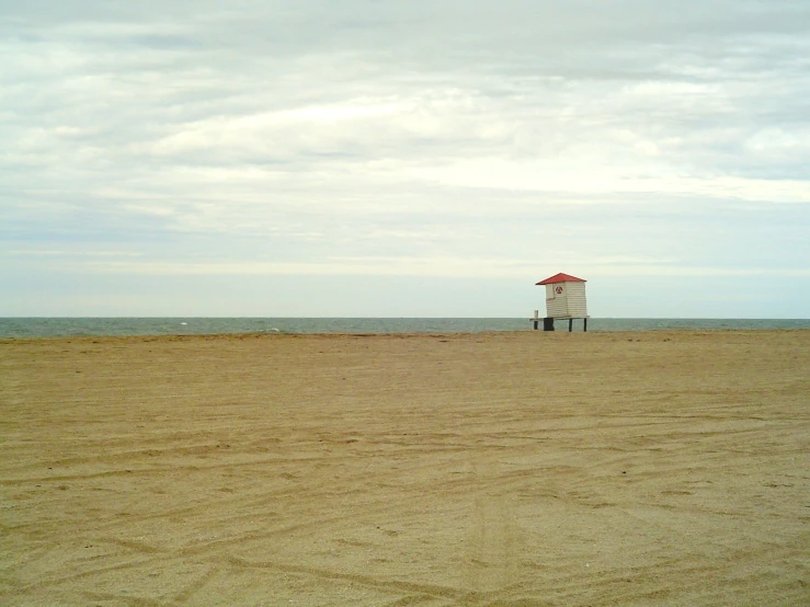 a life guard tower on the beach in the sand