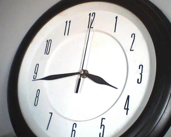 a black and white clock with one minute showing