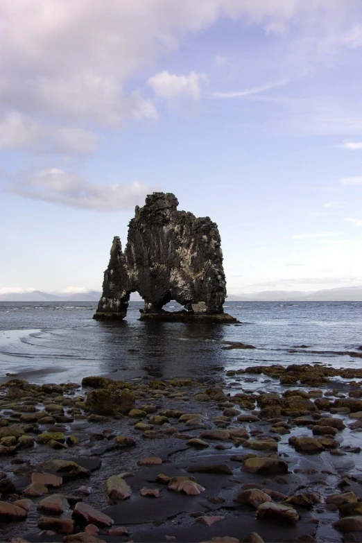 a large rock in the middle of water