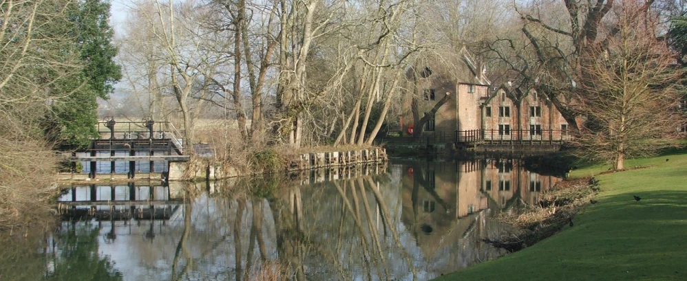 a wooden bridge crosses over a calm lake