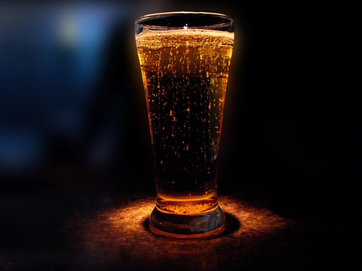 a glass of beer sits on the table