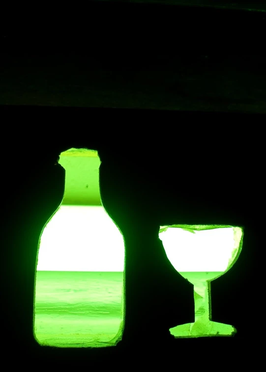 a wine glass and bottle are shown with the light from a nearby window