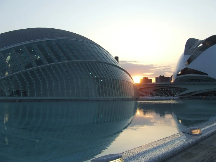 the large building is reflected in the water