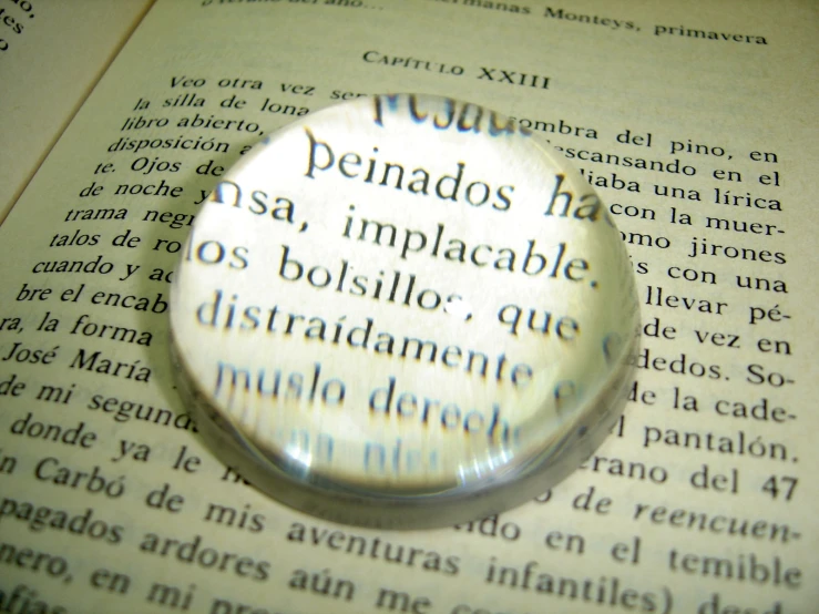 a close up of a magnifying glass on top of a book