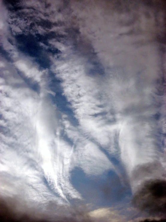 a view from below clouds and a plane