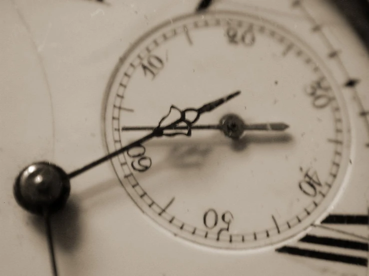 an antique clock with the hands and numbers showing