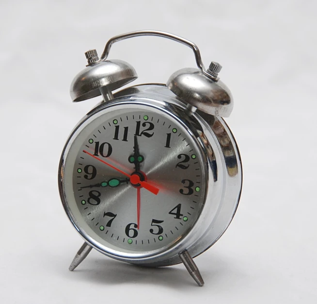 a alarm clock sitting on top of a white surface