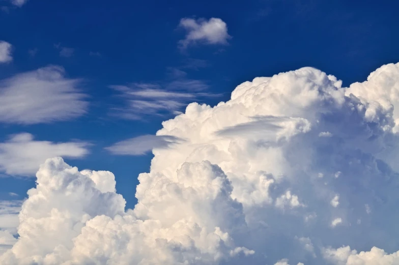 white clouds are seen above a blue sky