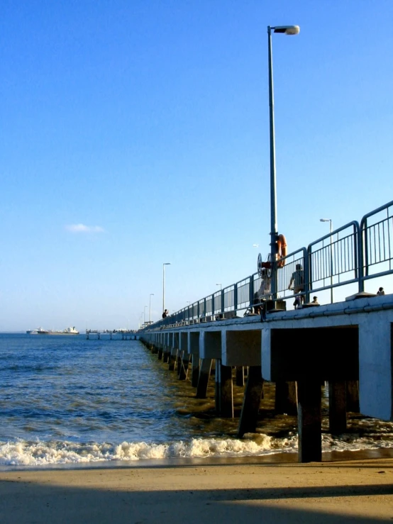 a pier with some people walking on it