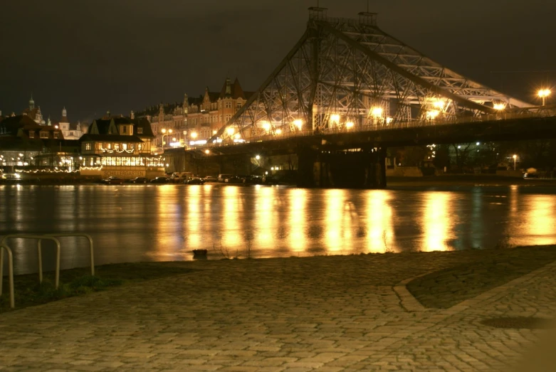 a large bridge over a lake with lights reflecting on it