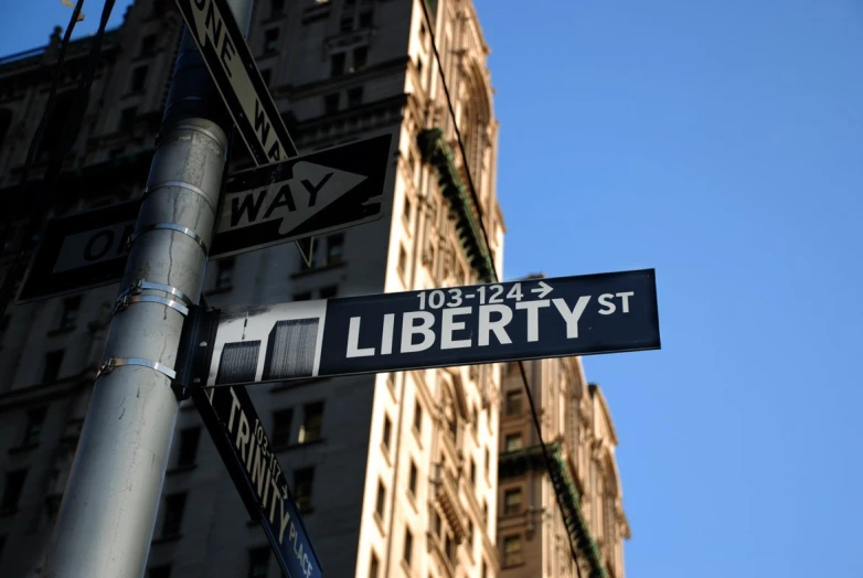 a street sign next to the corner of liberty and east 34th