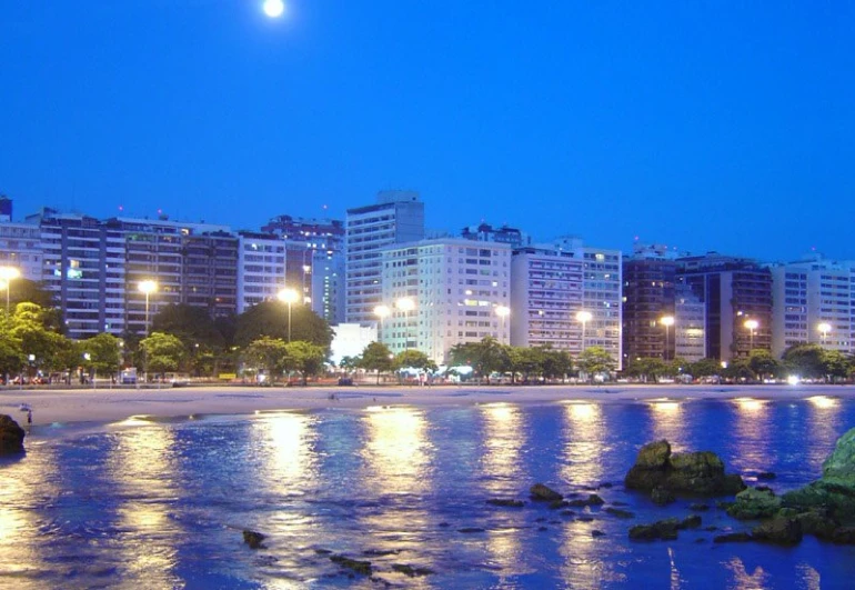 a nighttime city scene with buildings lit up