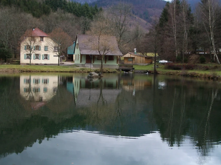 an old house is sitting by the water