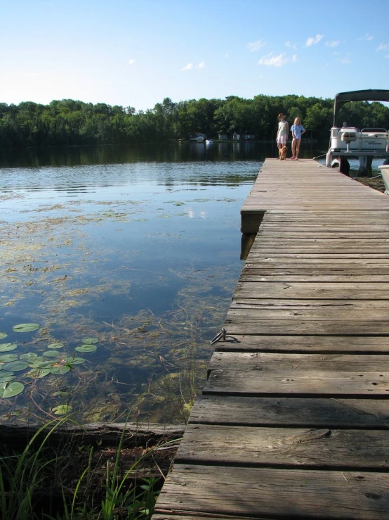 a wooden bridge is reflected in the water