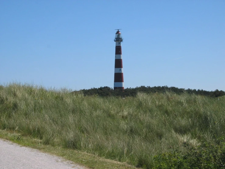 a light house sitting on top of a hill