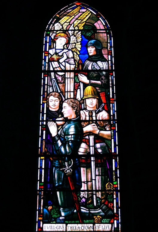 a stained glass in a dark area with a knight on it