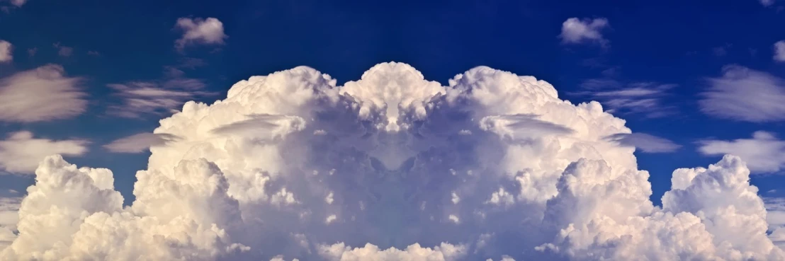 white cumille clouds, like the one above, are towering into the blue sky