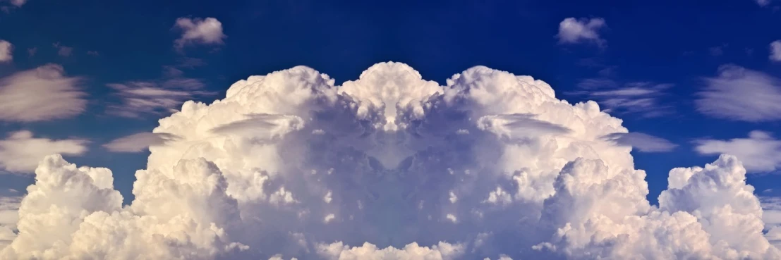 white cumille clouds, like the one above, are towering into the blue sky