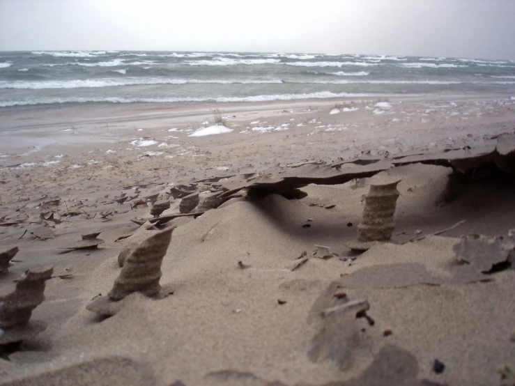 the sand has been eroded and placed in front of the ocean