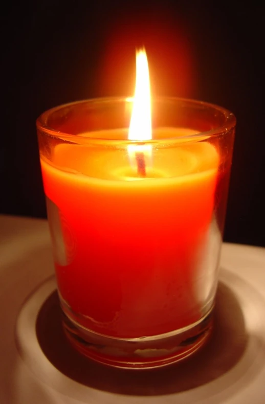 close up of lit candle on surface