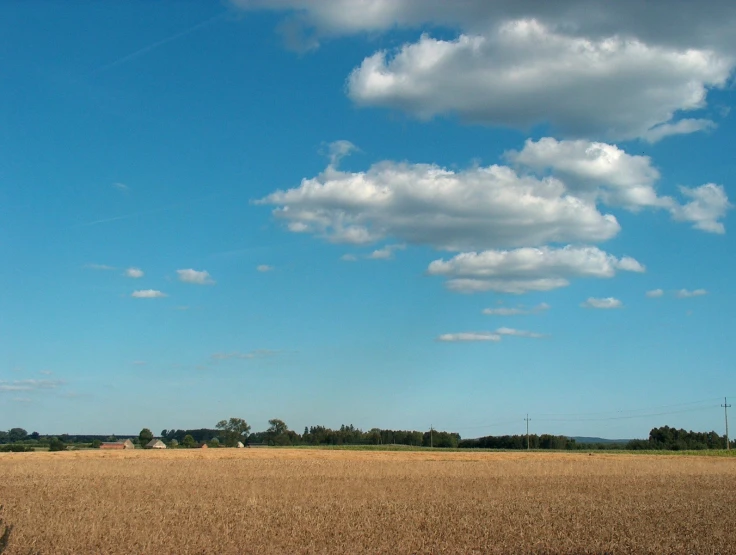 a rural area with clouds in the sky