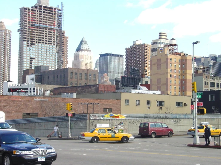 an intersection with vehicles and buildings in the distance