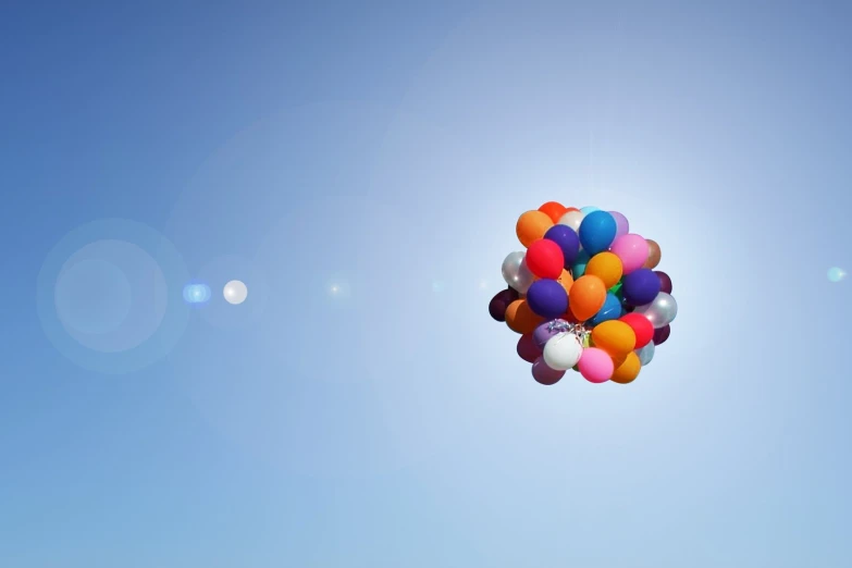 a cluster of balloons floating in the air