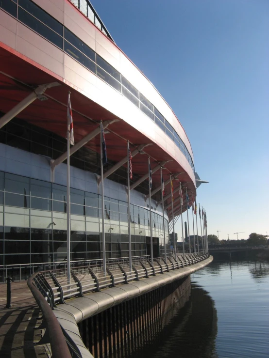 the outside of an arena in the water near grass and metal