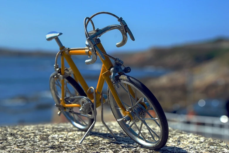 a yellow bicycle that is on the ground