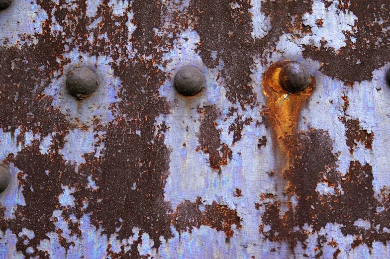 close up view of rusted metal and the background has small circles