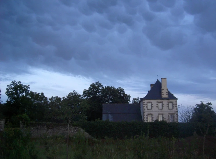 the dark, cloudy sky above a large building