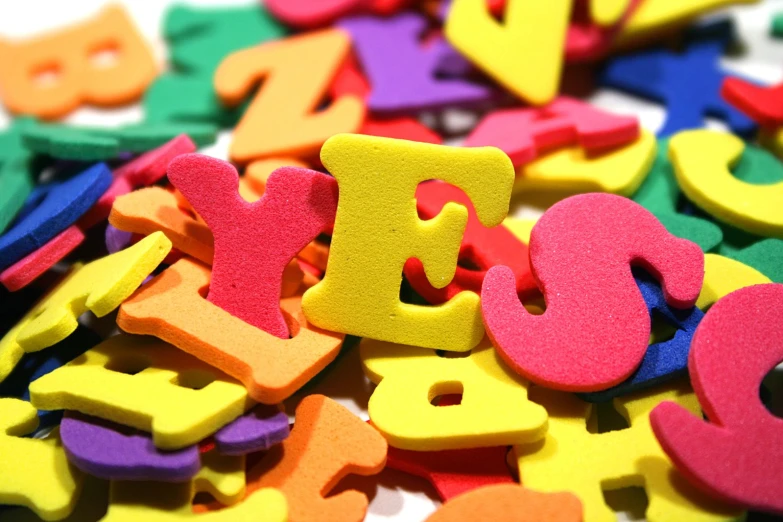 colorful 3d letters sitting in a pile on top of a white table